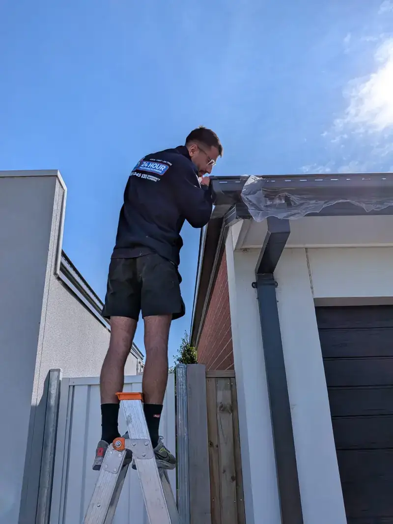 Roof plumber working on gutter in Burwood